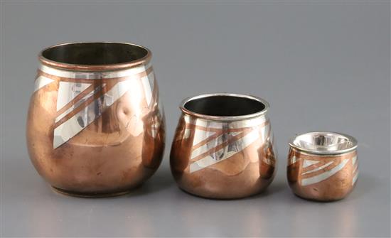 A graduated set of three Christofle Dinanderie Luc Lanel silver inset copper vases, tallest 4in.